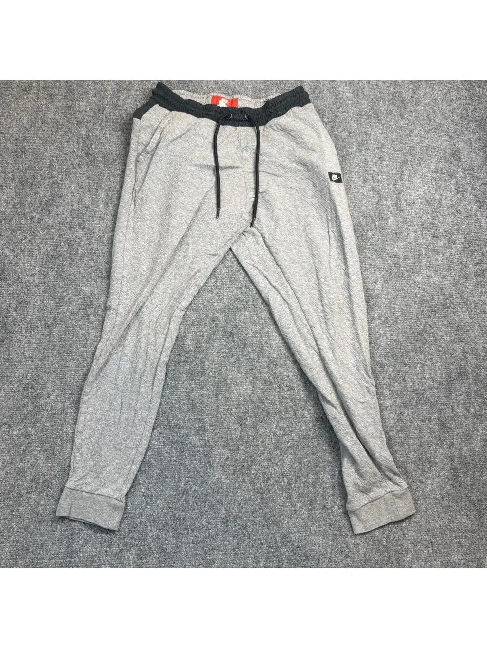 Nike gray joggers with black waistband and drawstring, size S